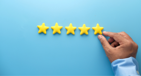 A person placing five gold stars to indicate customer satisfaction. 