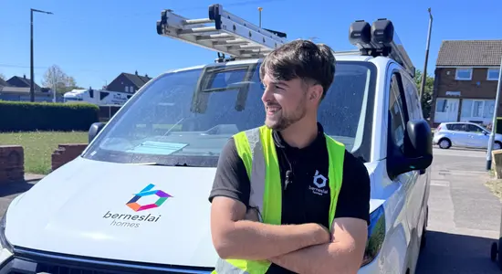 A member of staff standing in front of a Berneslai Homes van.png