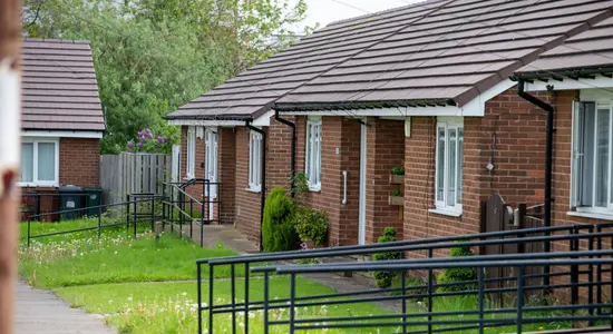 Front entrances to different bungalows on a street.png